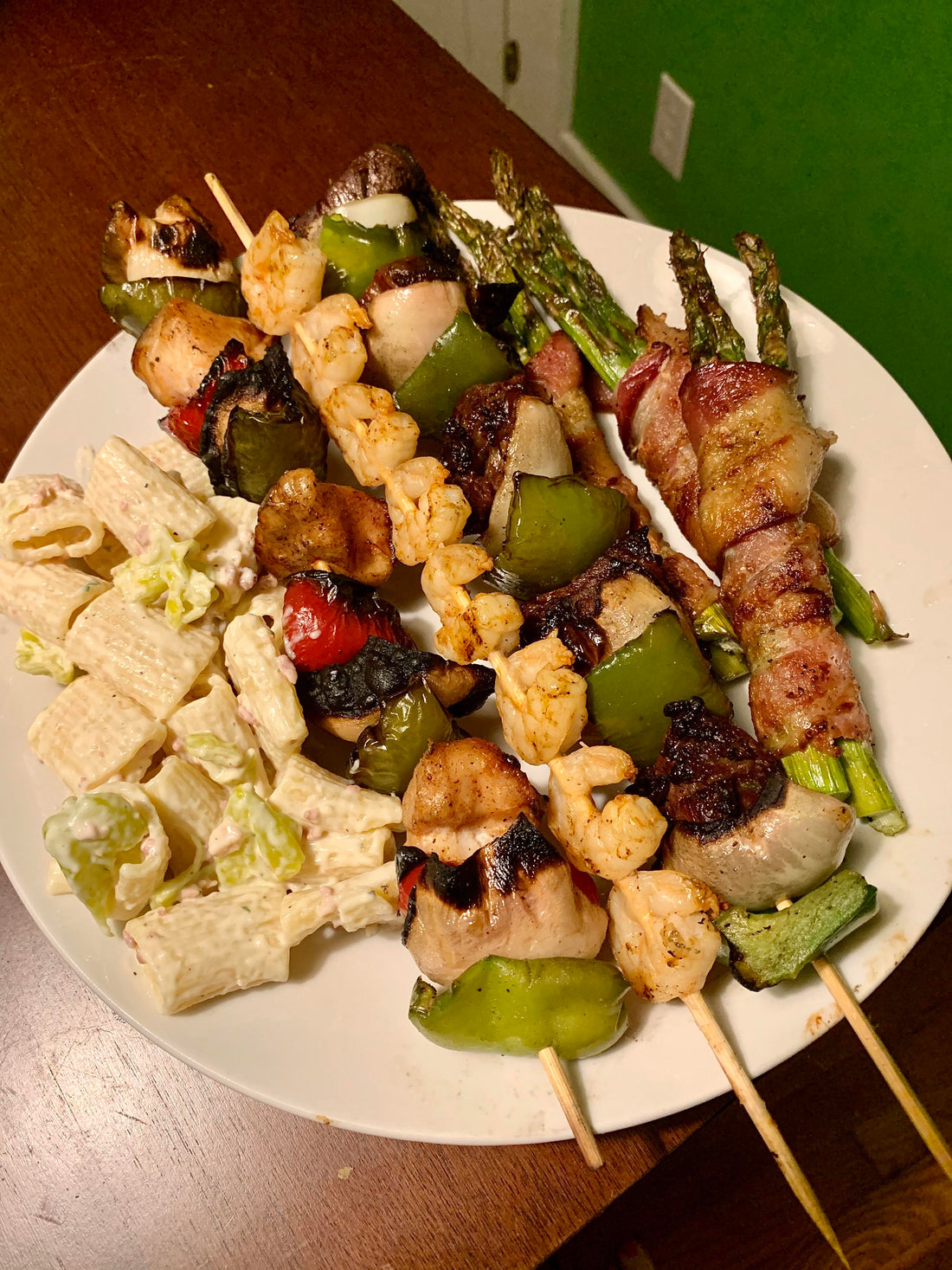 Steak, Chicken & Shrimp Skewers with bacon wrapped asparagus and pasta salad.