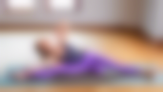 Create an image of a dancer in a yoga pose, wearing yoga gear that is designed for dancers' specific needs. The dancer should be in a graceful pose, surrounded by essential yoga gear such as a yoga ma