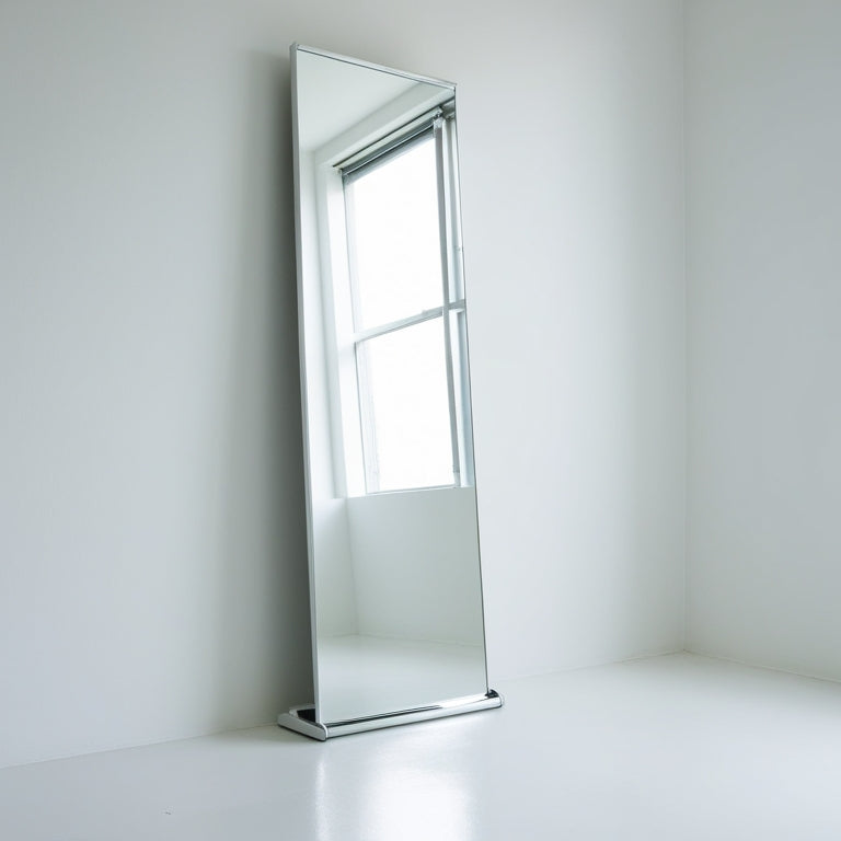 A minimalist, bright white room with a sleek, floor-to-ceiling rolling mirror standing against a wall, its reflective surface gleaming, surrounded by empty space and soft, natural light.